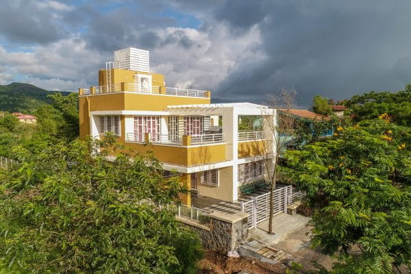 Bungalow at dusk — Sahyadri backdrop